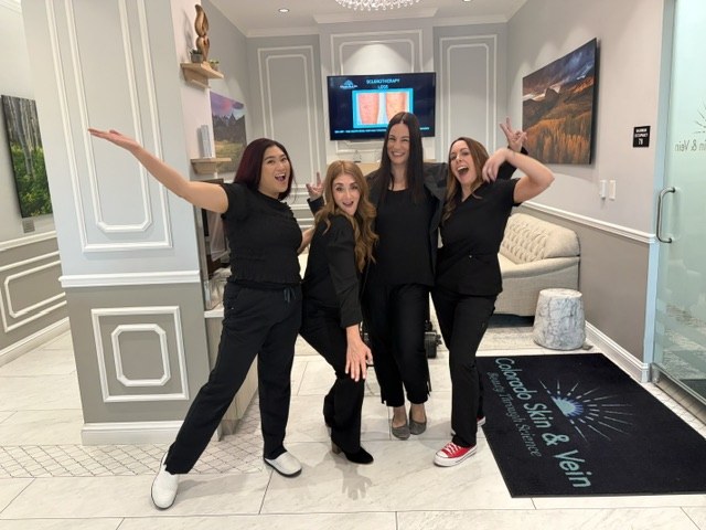 The Colorado Skin & Vein team laughing together in the practice lobby